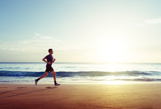 Man Running On Tropical Beach At Sunset