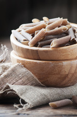 Raw buckwheat pasta on the wooden table
