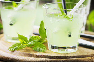Green sweet cocktail with mint and ice