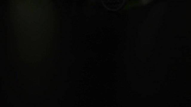 Caipirinha with cachaca, sugar and lime, bar tools on black background