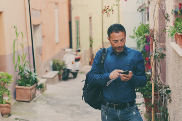 Tourist man talking at the phone in the city center during his t