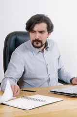 portrait of attractive serious businessman working with document