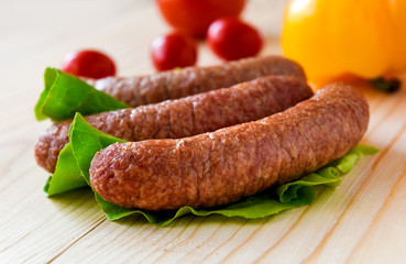 sausage with vegetables served on a  wooden board