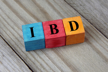 IBD (Inflammatory Bowel Disease) acronym on wooden background