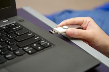 Fototapeta na wymiar Virus USB thumb drive plug in to laptop computer port