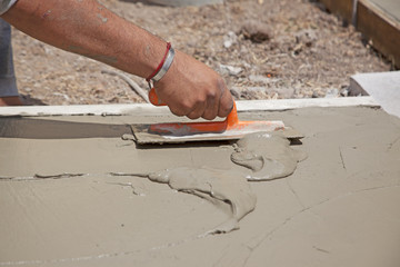 Trowel and cement, leveling the floor