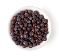bowl of juniper berries isolated on white, from above