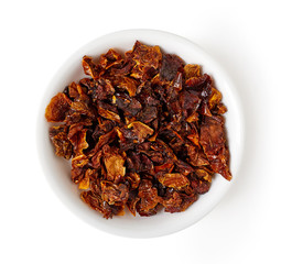 bowl of tomato flakes isolated on white, from above