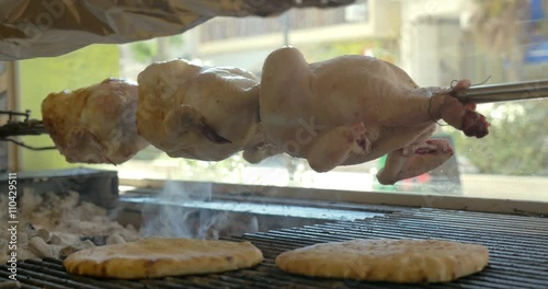 Three Chickens On Spit Roasting On Charcoals And Pitas