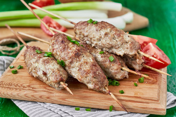 Barbecued kofta -traditional shish kebab from lamb meat with vegetables. horizontal