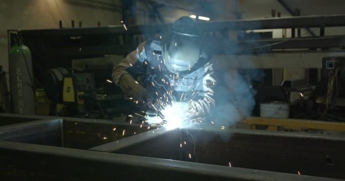 Closer shot of the welding process of a big metal part of the equipment