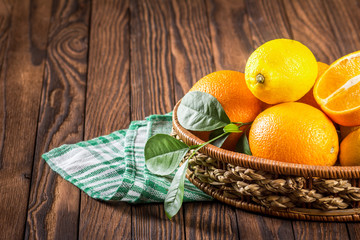 oranges and lemons in the basket on the table