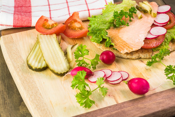 Fresh homemade pita sandwich with hot smoked salmon, letuce and vegetables.