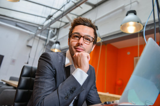Portrait of smiling Businessman posing  in coworking office