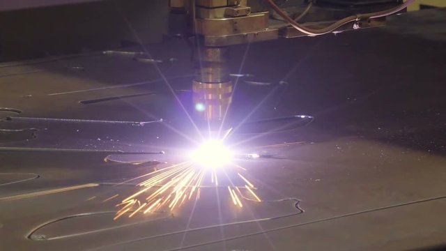 A plasma cutter making patterns out of the metal sheet this is to be used to assemble set of equipments