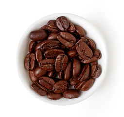 Bowl of coffee beans isolated on white, from above