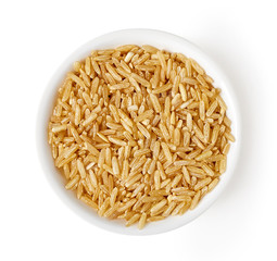 Bowl of brown rice isolated on white, from above