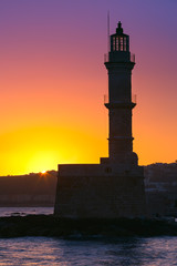 Lighthouse in old harbour of Chania at sunrise, Crete, Greece