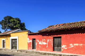 Old, colorful painted houses along cobbled street in colonial city of Antigua, Guatemala