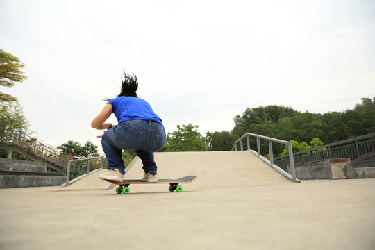 skateboarding woman riding skateboard at skatepark