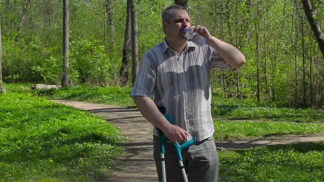 Disabled man drink water in the park