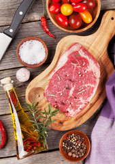 Raw beef steak with spices and herbs