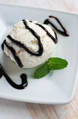 Vanilla ice cream with a chocolate sauce