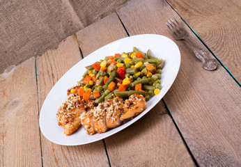 Mixed vegetables in a plate and chicken