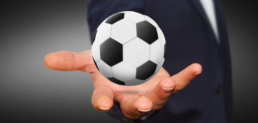 Businessman holding football in his hand