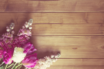 flowers on wooden top / overhead of flowers arranged on a wooden top