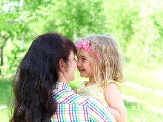 Fototapeta premium mother playing with her little daughter on nature