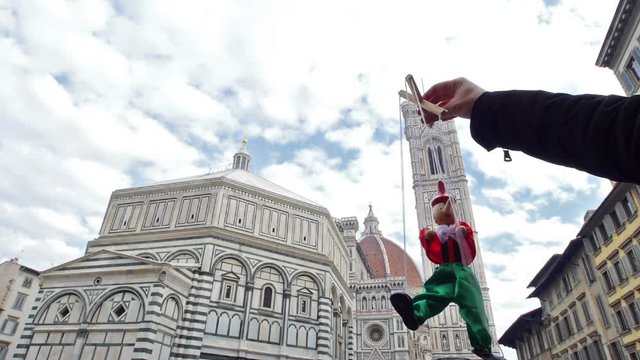 Italy puppet Pinocchio and the cathedral, baptistery Florence