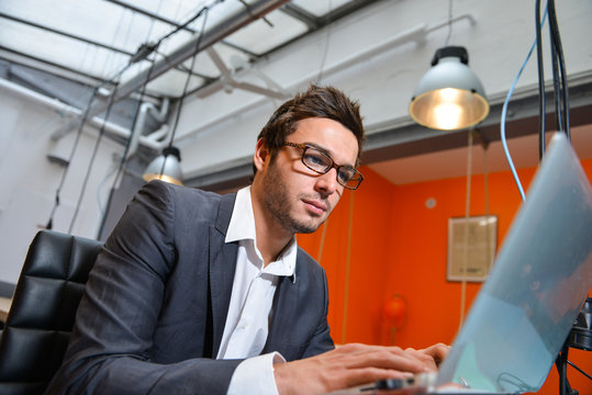Portrait of smiling Businessman posing  in coworking office