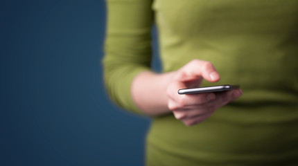 Young woman holding smarthphone in hand