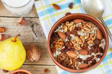 Homemade granola with nuts, raisins and seeds in a ceramic bowl for a healthy Breakfast
