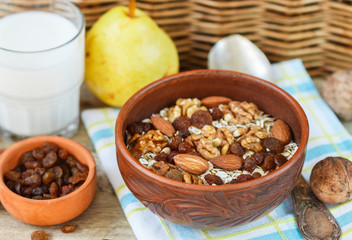 Homemade granola with nuts, raisins and seeds in a ceramic bowl for a healthy Breakfast
