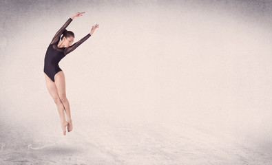 Fototapeta na wymiar Modern ballet dancer performing art jump with empty background