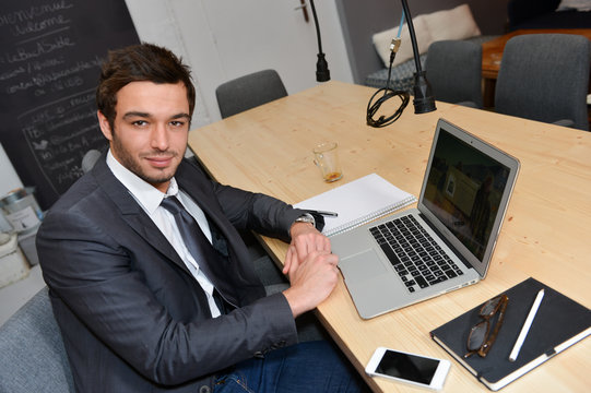 Portrait of smiling Businessman posing  in coworking office