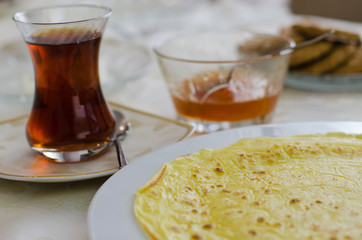 Delicious breakfast from pancakes, tea , sweet and biscuits