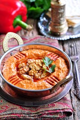 Muhammara dip of sweet peppers with walnuts, cumin, garlic and olive oil.