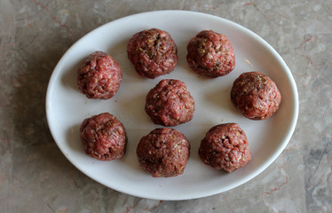 Raw Meatballs on White Plate