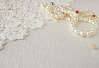 Knitting crochet lace background with pearl necklace