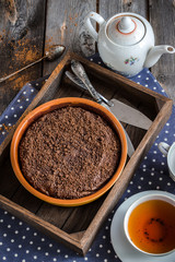 Fototapeta na wymiar Chokolate cake in wooden box and cup of tea