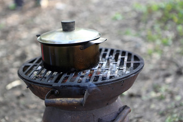 Saucepan with water on a grill