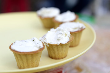 Tartlets with cheese on yellow plate