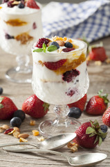 Yogurt with fruits on wooden table