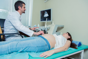Obraz premium pregnant woman laying on the couch during ultrasound checking 