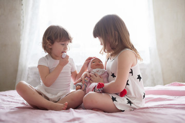 girls siblings children playing doctor with toy at home