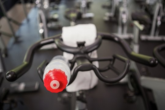 Bottle of water and napkin on exercise bike