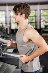 Fototapeta premium Man running on thread mill